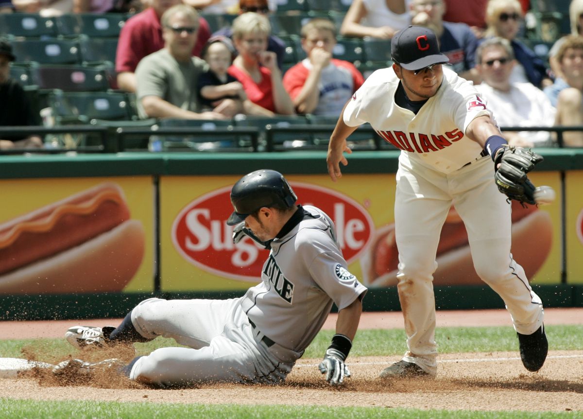 Ichiro Suzuki slides into third base as Cleveland third baseman Jhonny Peralta fields the throw in the fourth inning. (Associated Press / The Spokesman-Review)