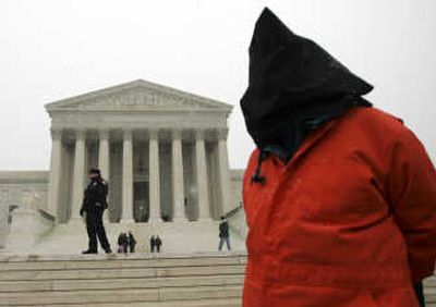 
A demonstrator, wearing a prison-like jumpsuit,  stands  outside the U.S. Supreme Court  on Wednesday. Associated Press
 (Associated Press / The Spokesman-Review)