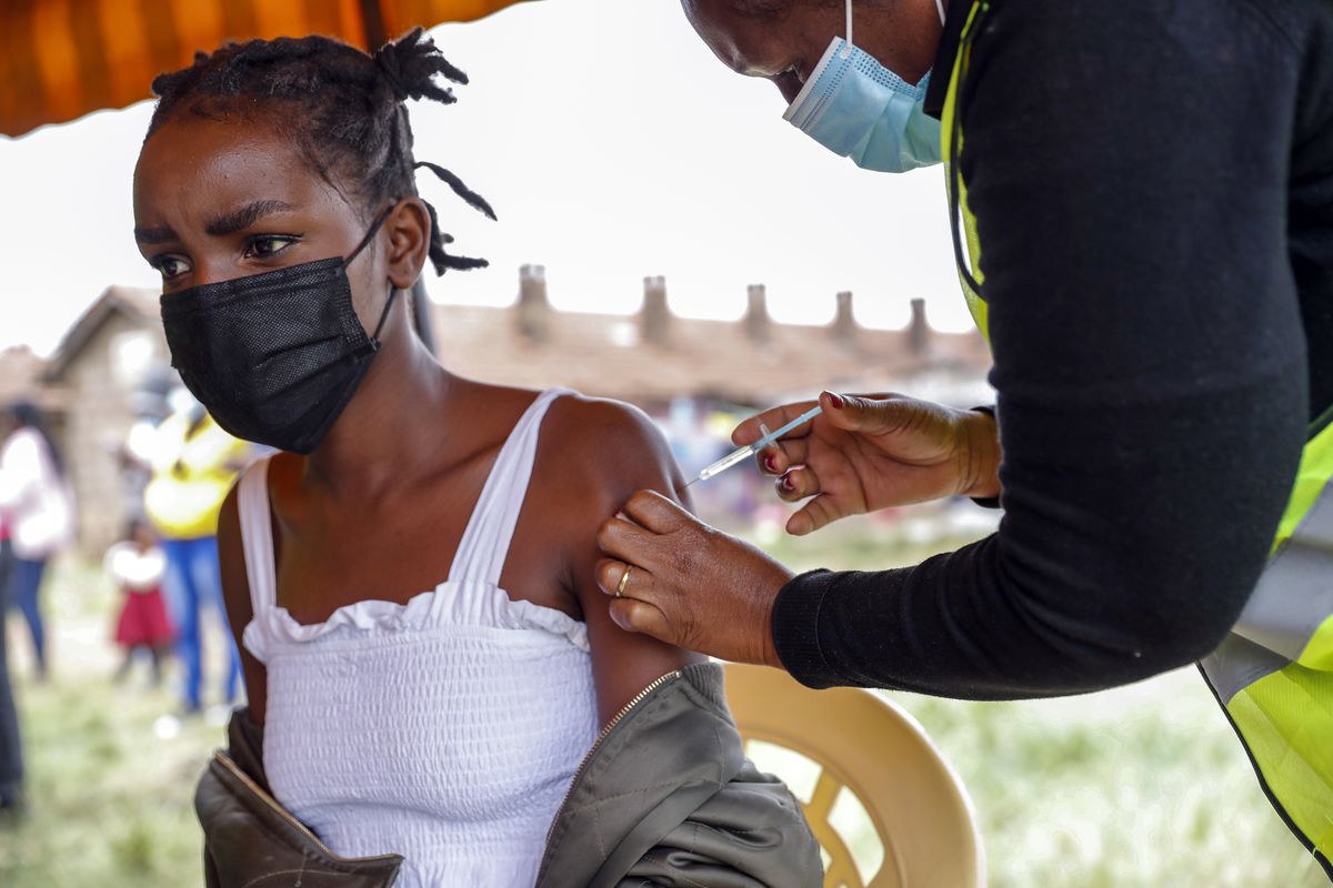 A Kenyan woman receives a dose of AstraZeneca coronavirus vaccine donated by Britain, at the Makongeni Estate in Nairobi, Kenya Saturday, Aug. 14, 2021. In late June, the international system for sharing coronavirus vaccines sent about 530,000 doses to Britain – more than double the amount sent that month to the entire continent of Africa. It was the latest example of how a system that was supposed to guarantee low and middle-income countries vaccines is failing, leaving them at the mercy of haphazard donations from rich countries.  (Brian Inganga)