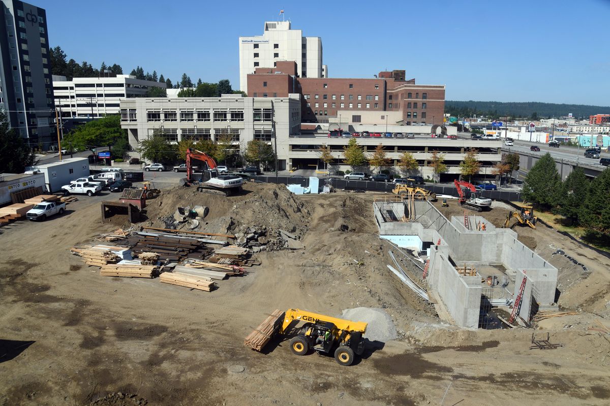 Construction crews work on the new $15 million common/cafeteria project, Thursday, Aug. 15, 2019, at Lewis and Clark High School. (Dan Pelle / The Spokesman-Review)