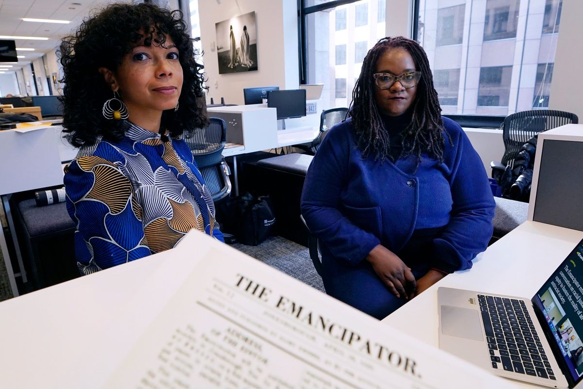 Amber Payne, left, and Deborah Douglas, co-editors-in-chief of the new online publication of “The Emancipator”, pose at their office inside the Boston Globe on Feb. 2 in Boston. (Charles Krupa)