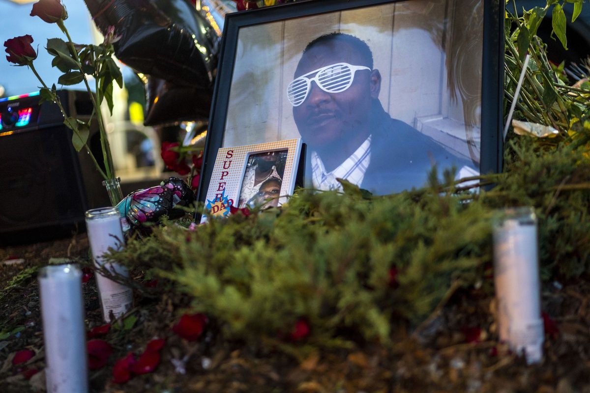 In this July 7, 2021 photo, items rest at a memorial for Leneal Lamont Frazier, in Minneapolis, at the site of his death. Frazier died early Tuesday, July 6, after his vehicle was struck by a squad car that police said was pursuing another driver linked to several robberies. A Minneapolis police officer has been charged with manslaughter and vehicular homicide in a fatal crash in July that occurred while the officer was pursuing a stolen vehicle, a prosecutor announced Friday, Oct. 22, 2021.  (Antranik Tavitian)
