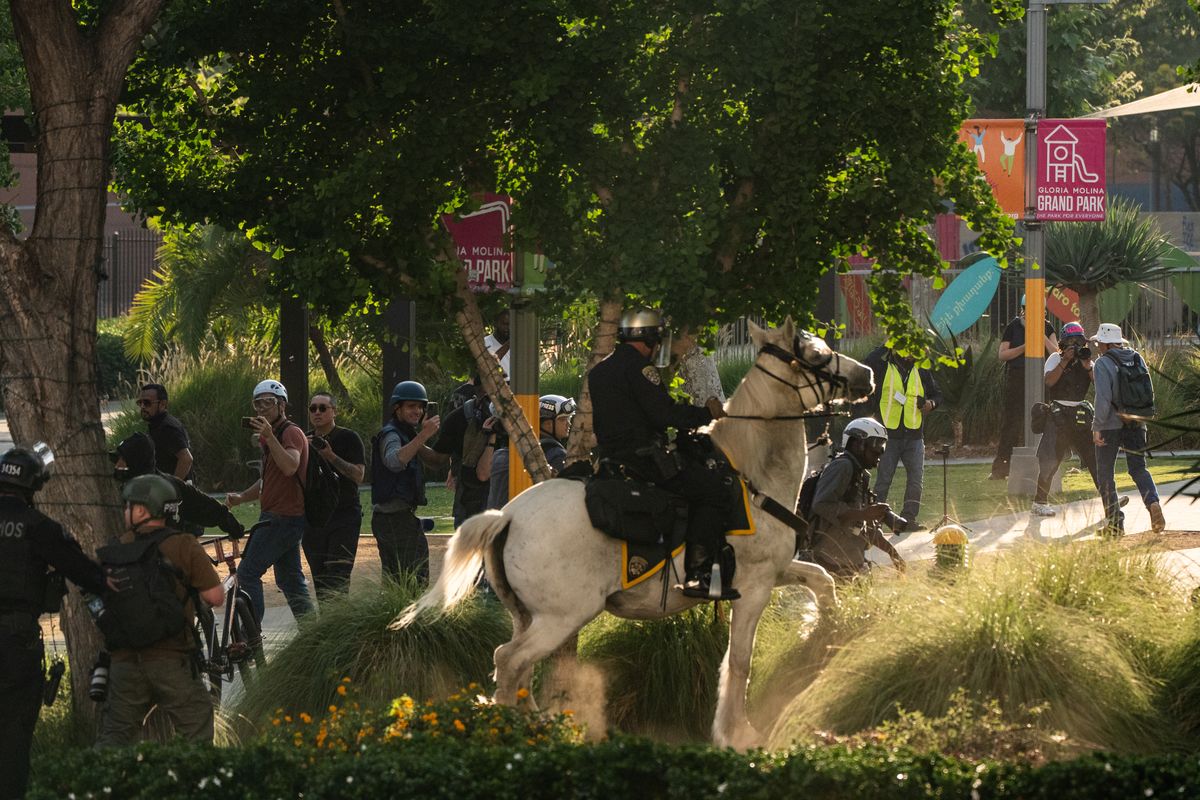 Law enforcement officers clear protesters from Gloria Molina Grand Park in Los Angeles on Wednesday.  (Salwan Georges/Washington Post)