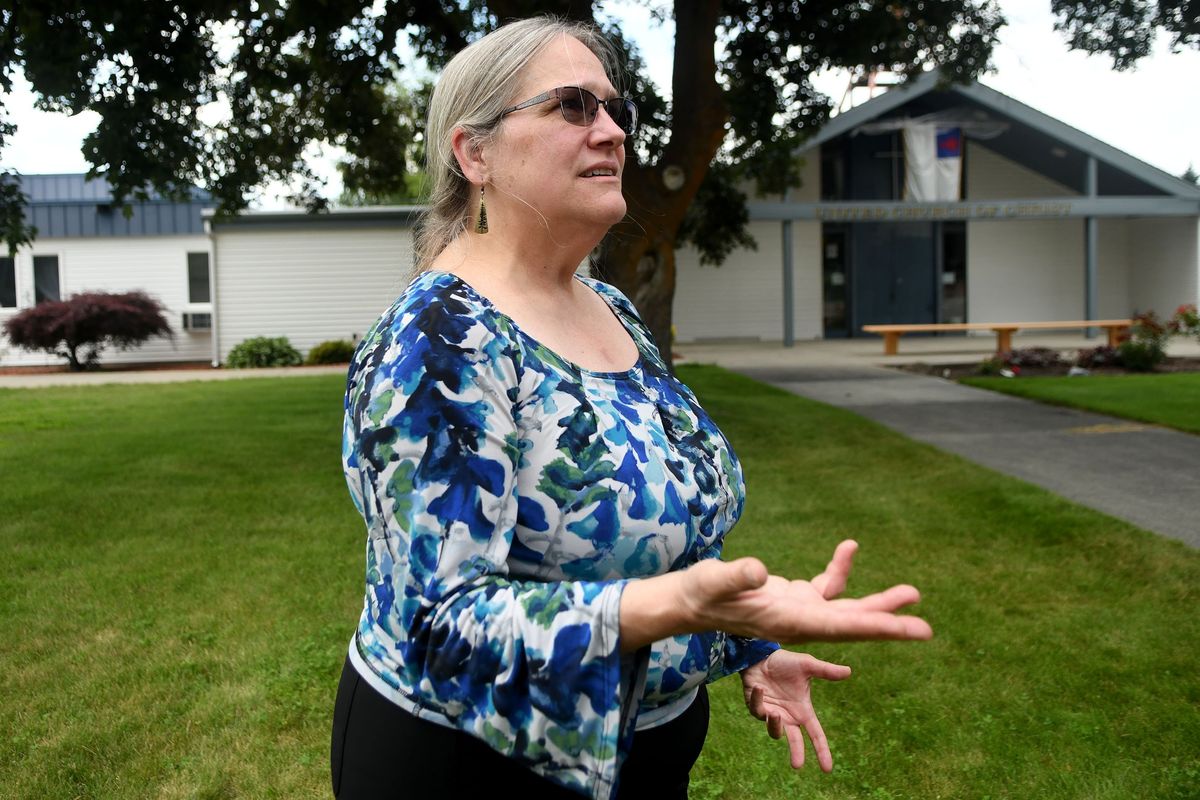 Rev. Gen Heywood talks Monday about the removal of the church’s pride flags and vandalism written on the grass at Veradale United Church of Christ.  (Kathy Plonka/The Spokesman-Review)