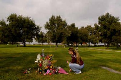 
Nancy Hodge sits in front of Laci Peterson's grave in Escalon, Calif., on Saturday. Scott Peterson, Laci's husband, was found guilty Friday in the murder of Laci and their unborn child. 
 (Associated Press / The Spokesman-Review)