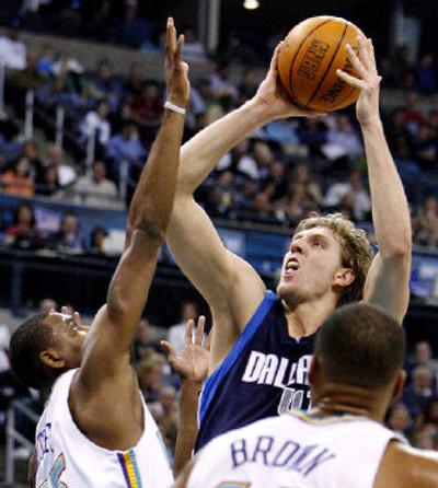 
Nowitzki's shot has produced at least 20 points in 31 straight games and an average of 31.3 in the playoffs.
 (Associated Press / The Spokesman-Review)