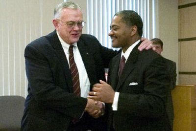 
Current Washington State University President V. Lane Rawlins, left, congratulates his successor, Elson S. Floyd. 
 (BRIAN IMMEL The Spokesman Review / The Spokesman-Review)