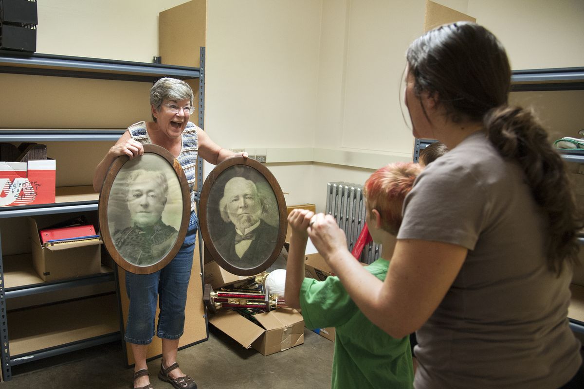 Instructor Paula Gibson-Smith displays portraits of Elizabeth and Samuel Havermale to Sarah Proctor and her son, Mason, on Thursday at the Montessori School on West Knox Avenue. Students from Jefferson and Balboa elementary programs will attend the new school. (Dan Pelle)