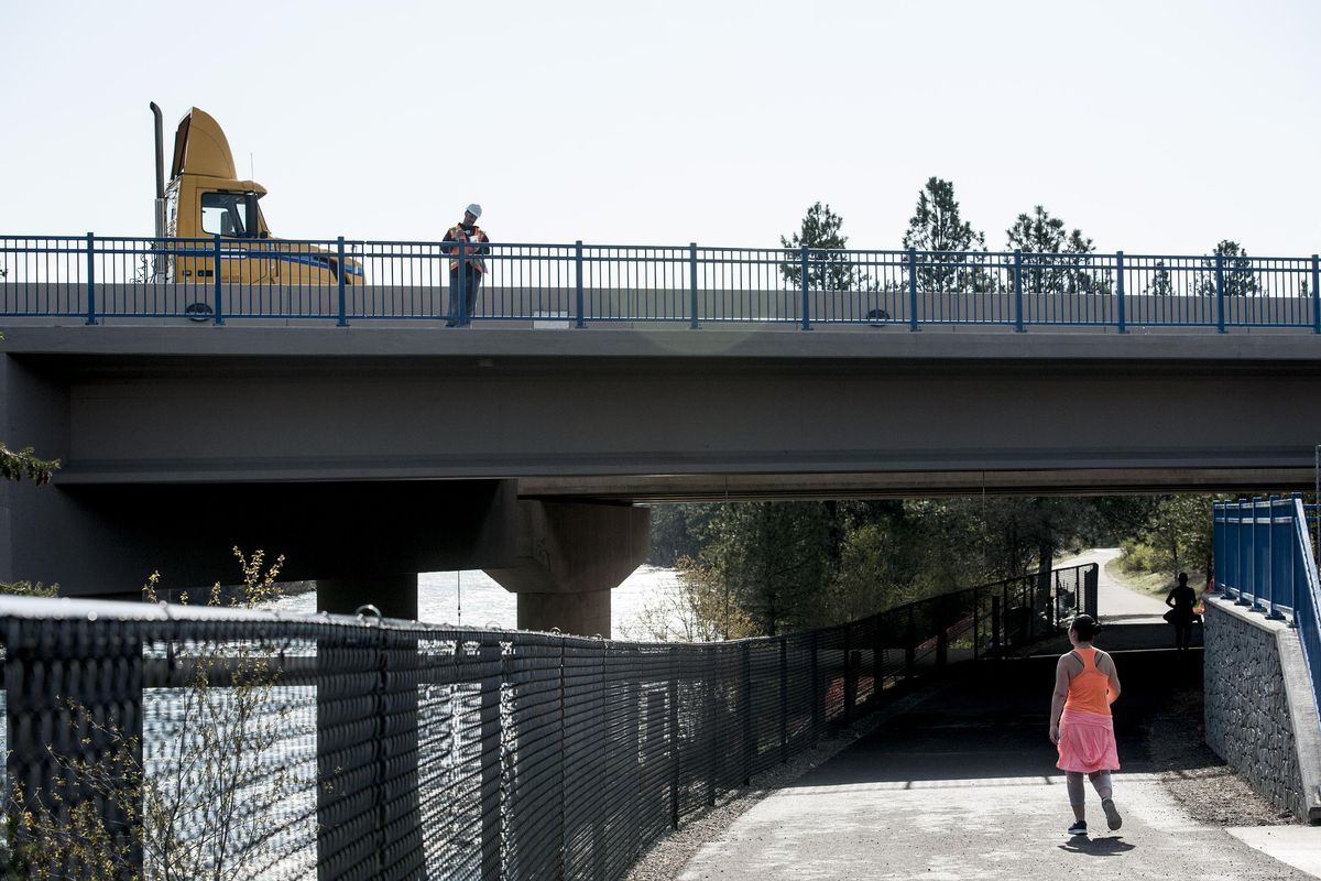 Rick Daly of Davidson Enterprises paints the Sullivan Bridge in Spokane Valley on Wednesday, April 19, 2017. (Kathy Plonka / The Spokesman-Review)