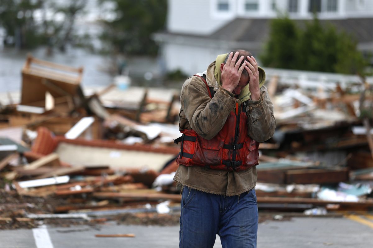 Brian Hajeski, 41, of Brick, N.J., reacts after looking at debris of a home that washed up on to the Mantoloking Bridge the morning after superstorm Sandy rolled through, Tuesday, Oct. 30, 2012, in Mantoloking, N.J. Sandy, the storm that made landfall Monday, caused multiple fatalities, halted mass transit and cut power to more than 6 million homes and businesses. (Julio Cortez / Associated Press)