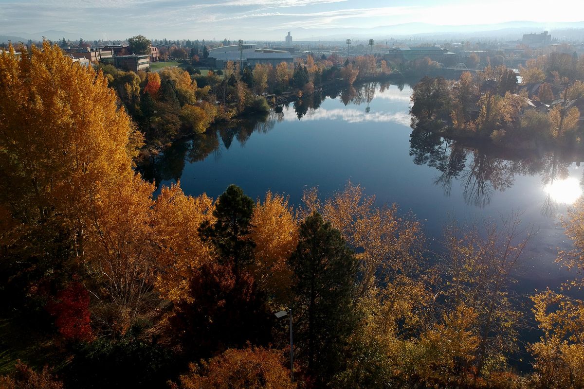 A low level drone camera image looks over fall colors and the Spokane River in downtown Spokane on Oct. 25, 2019. Small portable drones have made aerial photography more accessible for hikers and backcountry explorers. (Jesse Tinsley / The Spokesman-Review)