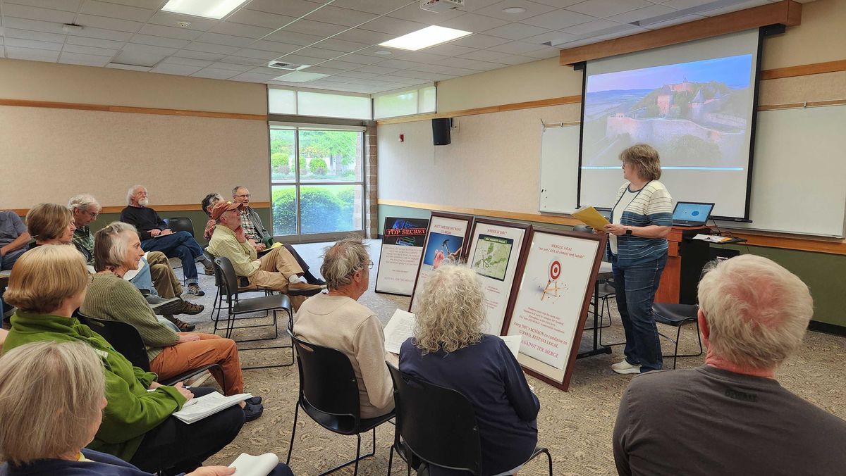 Susan Legel, a former accountant for the Dishman Hills Conservancy, presents at the May 14 event she helped organize, discussing the proposed merger with the Inland Northwest Lands Conservancy.  (Cannon Barnett / The Spokesman-Review)