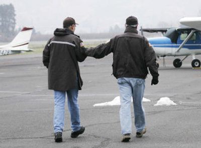 
Hood River County Sheriff Joe Wampler reaches to Officer Chris Guertin on Wednesday. 
 (Associated Press / The Spokesman-Review)