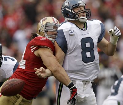 Seahawks quarterback Matt Hasselbeck fumbles as he is hit by San Francisco 49ers linebacker Travis LaBoy. (Associated Press)