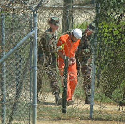 
A detainee is escorted to an interrogation session by U.S. military guards at Guantanamo Bay in Cuba in this 2002 file photo. 
 (Associated Press / The Spokesman-Review)