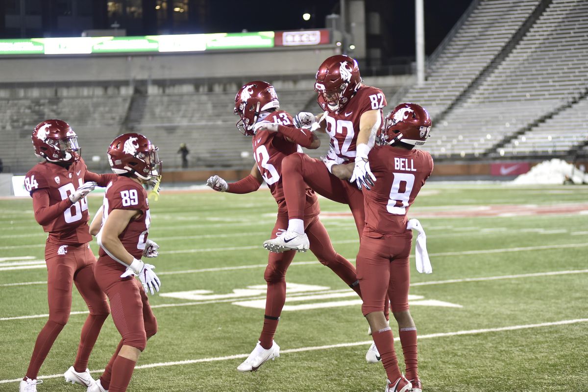 Washington State wide receiver Lucas Bacon (82) celebrates with teammates after catching a touchdown pass in the first half against Oregon in Pac-12 play last Saturday at Martin Stadium in Pullman. Despite Bacon’s TD, the Cougars lost their home opener, 43-29.  (Bob Hubner/WSU Athletics)