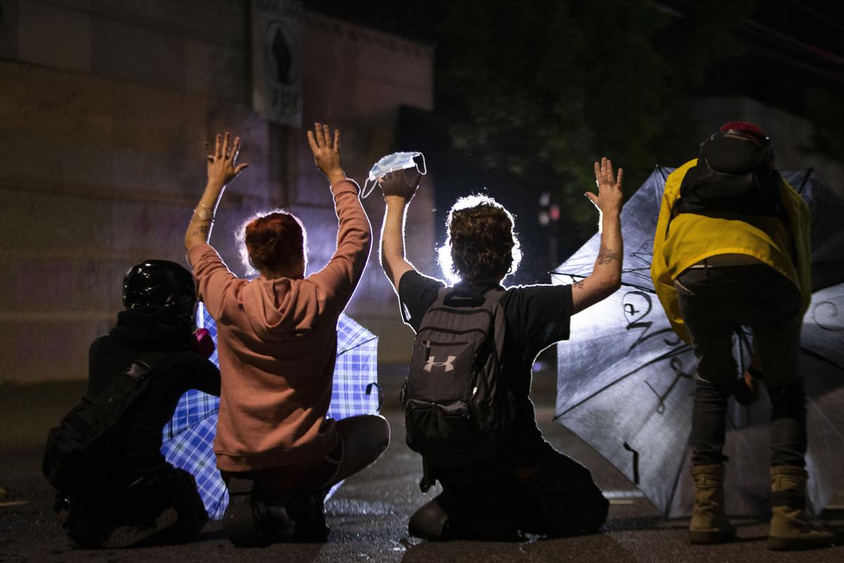 A march on the Portland police union headquarters Monday drew a rapid police response after someone set a fire next to the building.  (Beth Nakamura)