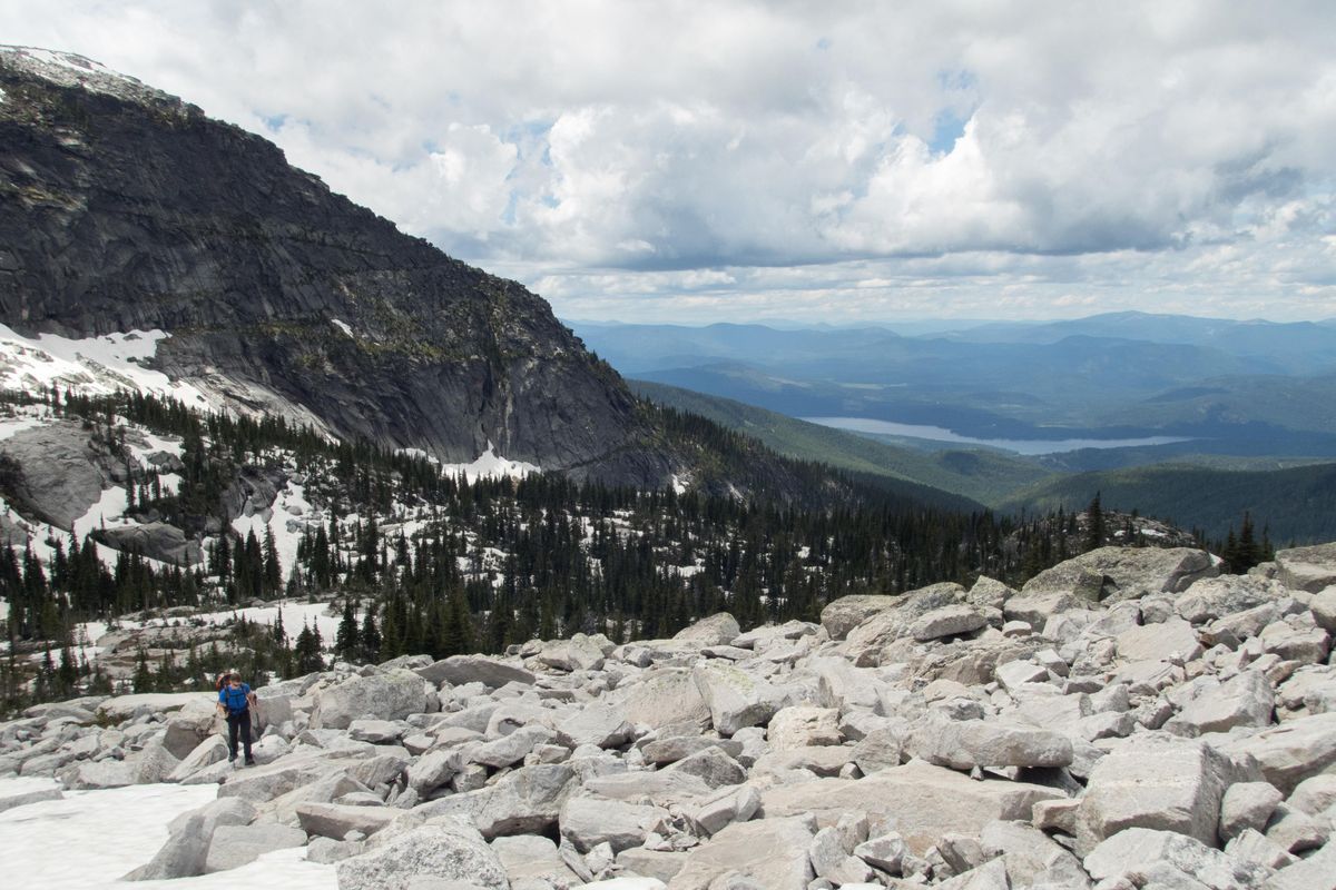 Kyle Breeding traverses a boulder field on his way to climbing Chimney Rock in North Idaho on Monday June 25, 2018. In the background is Priest Lake. ELI FRANCOVICH/THE SPOKESMAN REVIEW (Eli Francovich / The Spokesman-Review)