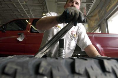 
Les Schwab employee Daniel Dustin pulls off old tires before mounting new ones for the upcoming winter driving season at the business in Coeur d'Alene.
 (Jesse Tinsley / The Spokesman-Review)
