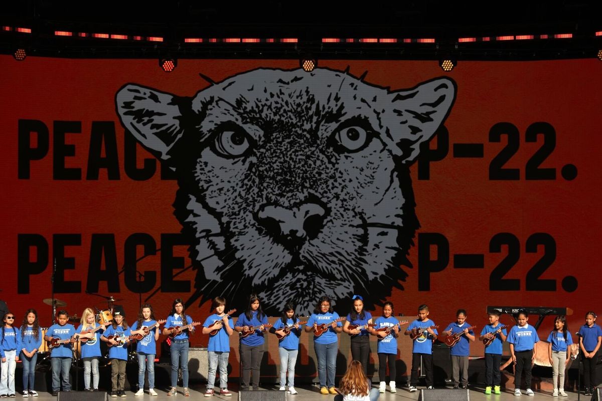 Students with San Pascual STEAM Magnet Elementary School sing there original song, “P-22 We Love You,” while playing ukuleles at the “celebration of life” for L.A.’s famous mountain lion, P-22, at the Greek Theater in Los Angeles on Saturday.  (Genaro Molina)