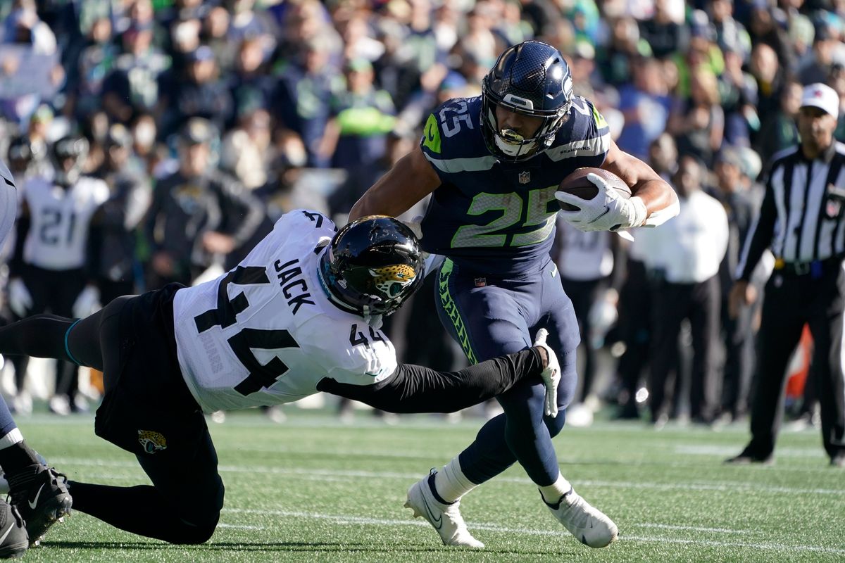 Seattle Seahawks Travis Homer (25) is tackled by Jacksonville Jaguars outside linebacker Myles Jack (44) during an NFL football game, Sunday, Oct. 31, 2021, in Seattle.  (Ted S. Warren)