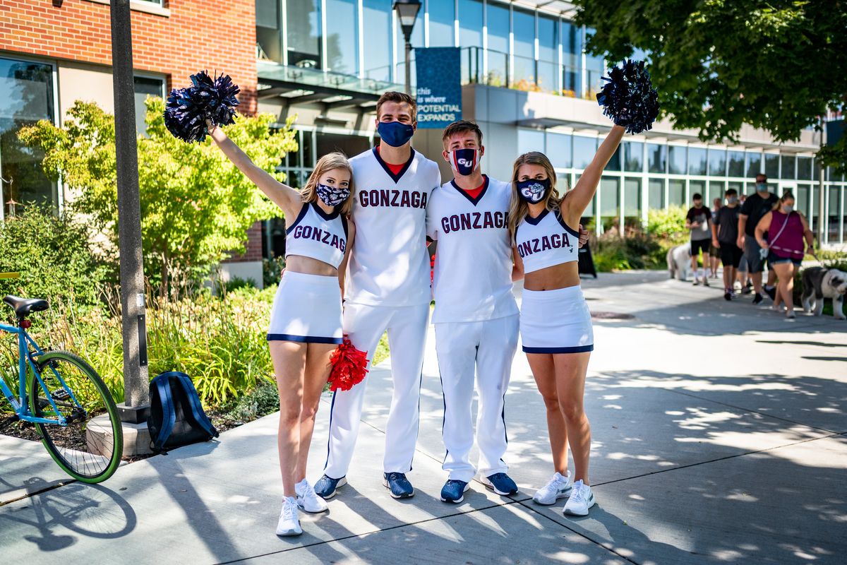 Gonzaga University cheerleaders Taylor Nichols, Ian Matthews, Jacob Evanger and Paige Bruland roam the campus on Wednesday, Aug. 26, 2020, helping new and returning students during move-in week.  (Colin Mulvany / The Spokesman-Review)