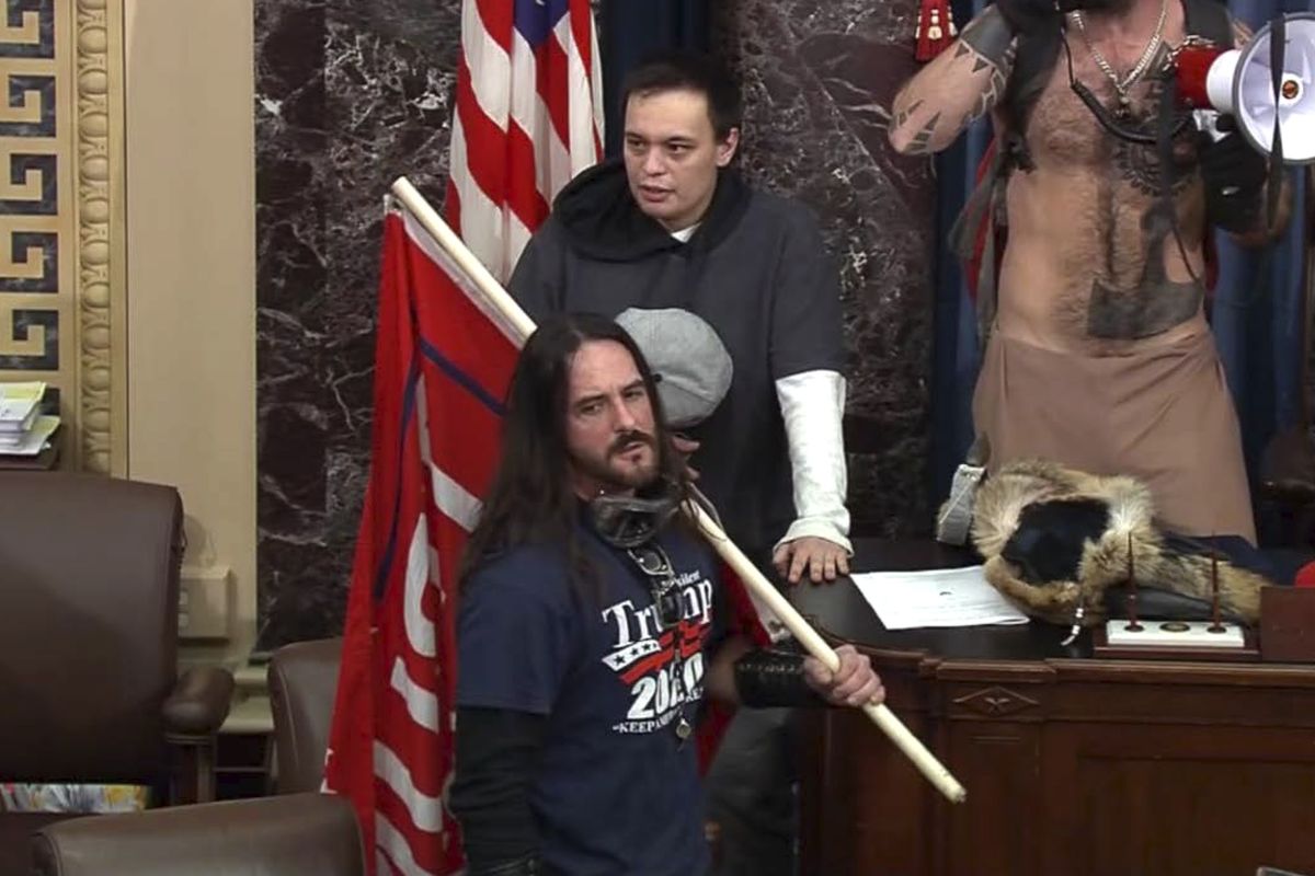 FILE - In this file image from U.S. Capitol Police video, Paul Allard Hodgkins, 38, of Tampa, Fla., front, stands in the well on the floor of the U.S. Senate on Jan. 6, 2021, at the Capitol in Washington. (HOGP)