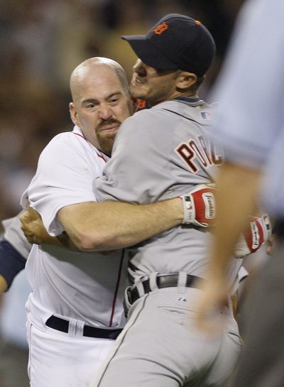 Kevin Youkilis, left, charged Detroit’s Rick Porcello on Tuesday and both were suspended Wednesday. (Associated Press / The Spokesman-Review)
