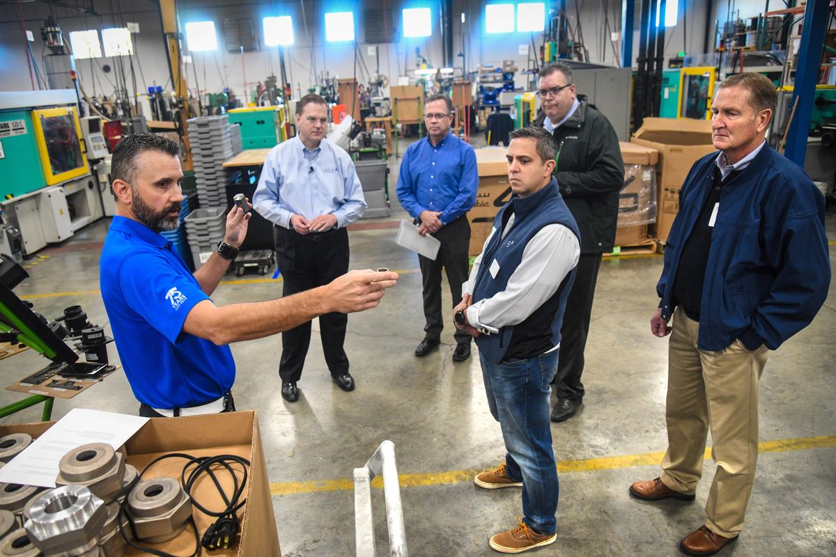 Marc Taylor, left, of Hotstart, offers information about the company to Kris Johnson, Association of Washington Business president and CEO; Greg Walters, of Hotstart; Clay Hill, AWB government affairs director; Rep. Mike Volz; and Rep. Jeff Holy, during a tour Wednesday. (Dan Pelle / The Spokesman-Review)