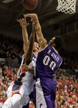 Gonzaga’s Gary Bell Jr. draws a foul while driving between Portland’s Kevin Bailey and Bryce Pressley. (Colin Mulvany)