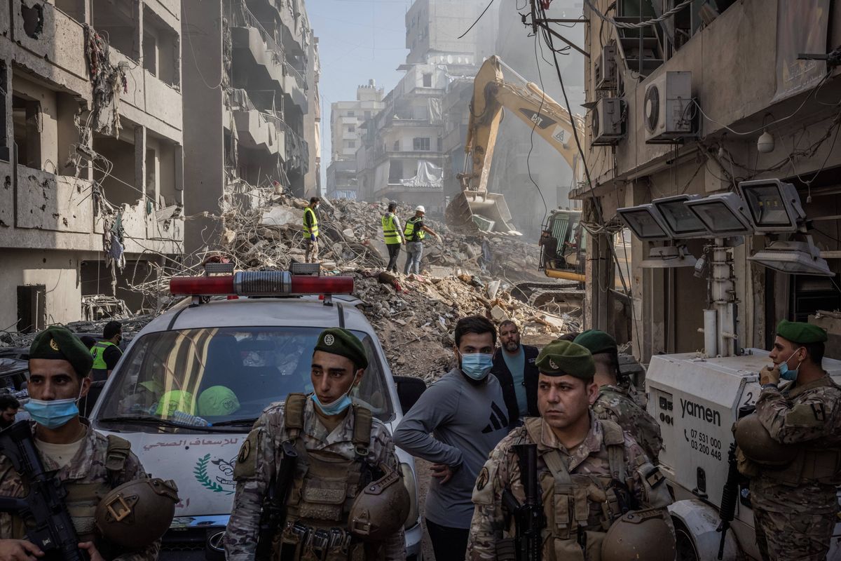 Soldiers from the Lebanese Armed Forces stand guard as emergency workers search for victims of an Israeli airstrike that hit the densely populated Basta district in Beirut early Saturday.  (Ed Ram/For The Washington Post)