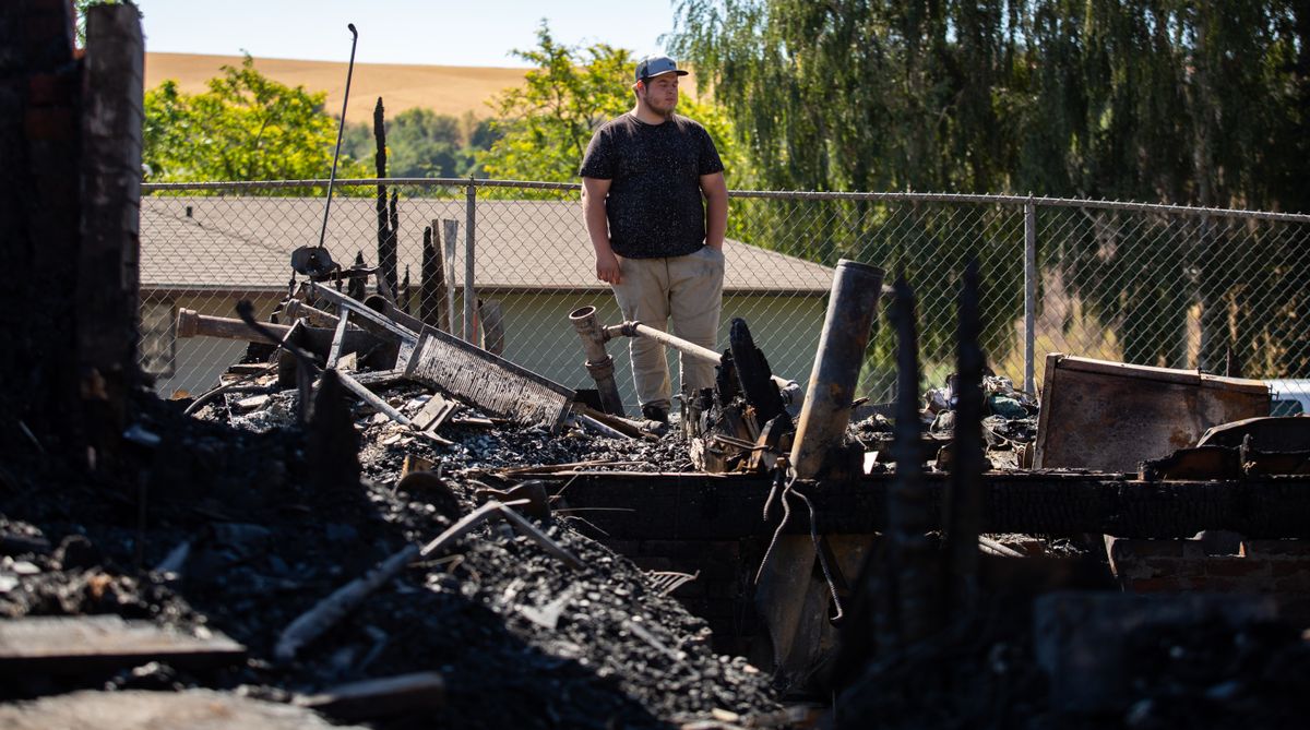 People clean up in Colfax after the fire Sept. 8, 2020 The