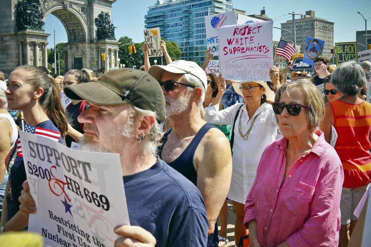 Protesters listen during a "Peace and Sanity" rally Sunday, Aug. 13, 2017, in the Brooklyn borough of New York, during a rally about white supremacy violence in Charlottesville, Va. (Bebeto Matthews / Associated Press)