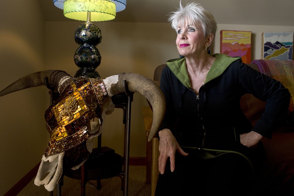 Artist Mary Jo Stauner sits next to a cattle skull with moasic at her home on Spokane’s South hill Wednesday. (Jesse Tinsley)