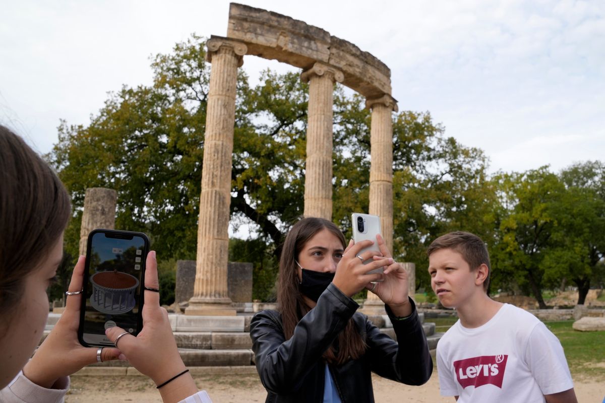 School students use a mobile app Wednesday at the ancient site of Olympia in southwestern Greece.  (Associated Press)