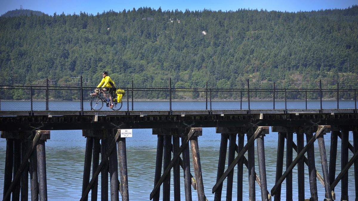 Nick Deshais crosses the Tommy Thompson trestle near Anacortes, Wash., on Wednesday as he sets out on his 416-mile journey east. (Dan Pelle)