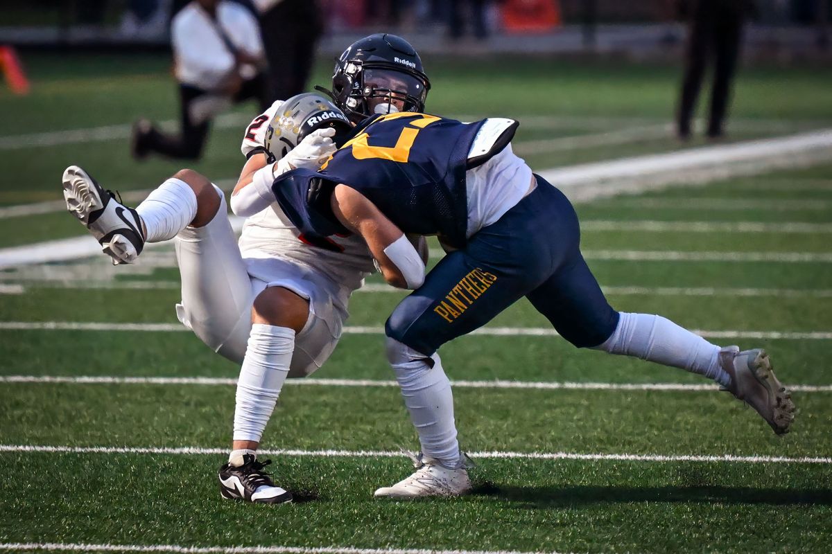 Lewis and Clark free safety Mason Kershaw (2) tackles Mead running back James Fraham (#23) during the first half of a high school football game, Friday, Sept. 13, 2024, at Union Stadium.  (Colin Mulvany/The Spokesman-Review)