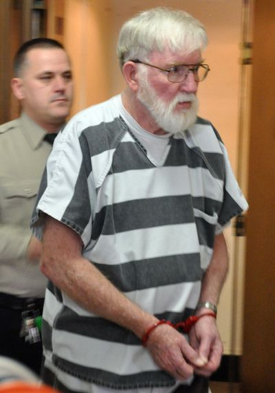 Carl V. Ericsson, 73, is led into a courtroom for a bond hearing in February on a murder charge in Madison, S.D. (Associated Press)