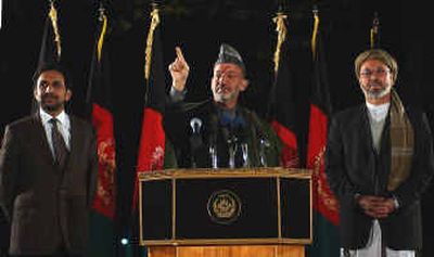 
Afghan President Hamid Karzai, center, flanked by Vice President Ahmad Wali Masood, right, and second Vice President Karim Khalili, speaks during a press conference Thursday at the Presidential Palace in Kabul, Afghanistan.
 (Associated Press / The Spokesman-Review)