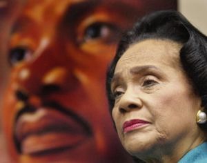 Coretta Scott King is shown in this 2003 photo in front of a portrait of Martin Luther King Jr.