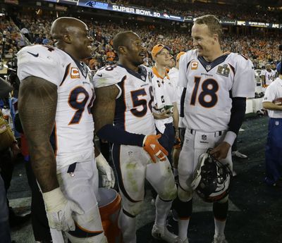 Denver Broncos DeMarcus Ware (94), Von Miller (58) and Peyton Manning (18) celebrate Super Bowl win. (David J. Phillip / Associated Press)