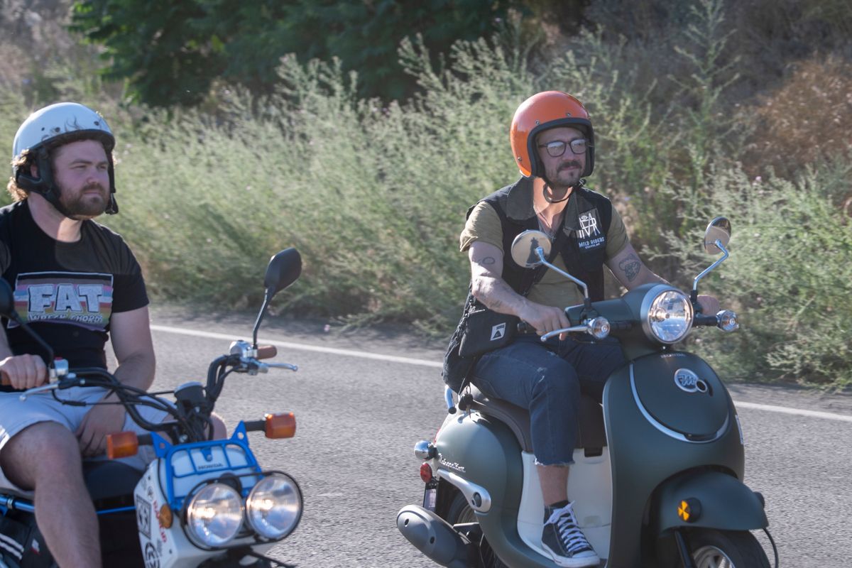 Ruben Villarreal, right, rides his new scooter with his club, the Mild Riders, down Upriver Drive Monday, July 11, 2022 in Spokane, Washington. Villarreal had his scooter stolen and his club raised money to replace it.  (JESSE TINSLEY)