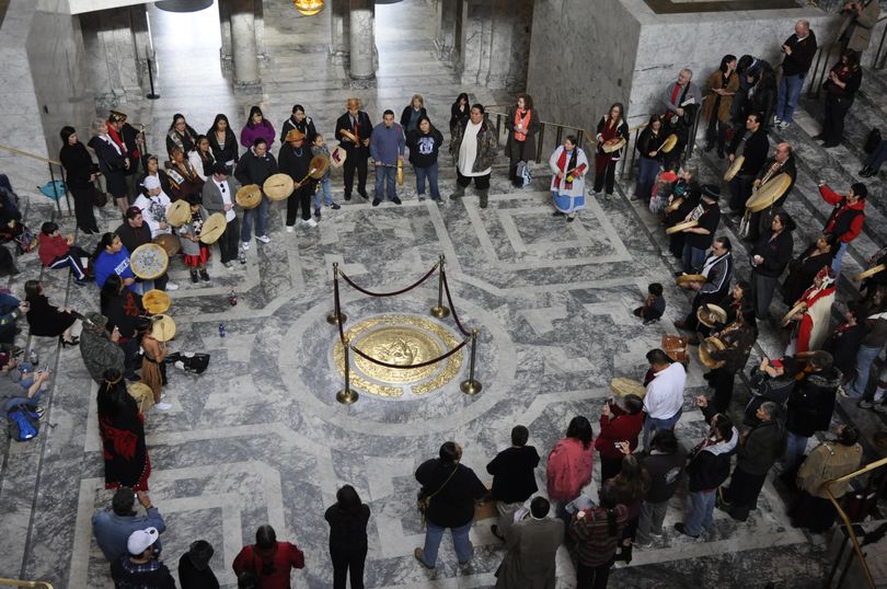OLYMPIA -- Tribal drummers form a drum circle in the Capitol Rotunda on Native American Lobby Day, Jan. 31, 2012. (Jim Camden)