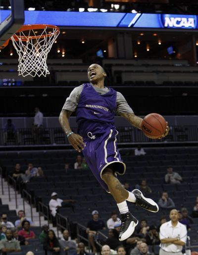 Washington's Isaiah Thomas soars to the basket to dunk during practice for an NCAA East Regional tournament college basketball game in Charlotte, N.C. (Associated Press)