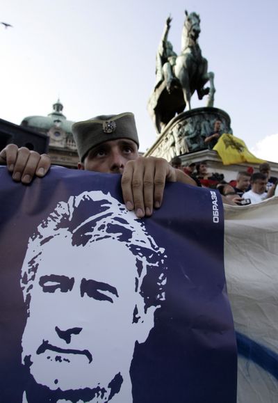 A man wearing a traditional hat holds a picture of  Radovan Karadzic in Belgrade, Serbia, on Sunday.  (Associated Press / The Spokesman-Review)
