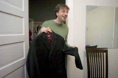 
Spokane Symphony conductor Eckart Preu shows of some of his more formal attire from the bedroom closet of his small Browne's Addition apartment. 
 (Photos by Colin Mulvany/ / The Spokesman-Review)