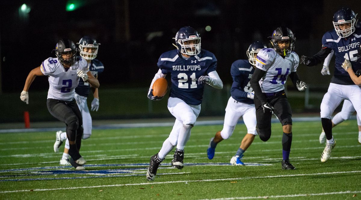 Gonzaga Prep’s Jake Parola (21) carries on a kickoff return against the Hanford Falcons in a playoff game at Gonzaga Prep on Nov. 2, 2018. The Bullpups beat the Falcons 28-24 in a nail-biting finish. (Libby Kamrowski / The Spokesman-Review)