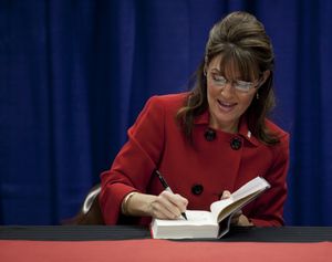 Sarah Palin signs her autograph at Barnes and Nobles during the first stop of her book tour in Grand Rapids, Mich. on Wednesday, Nov. 18, 2009. (Adam Bird / Fr104466 Ap)