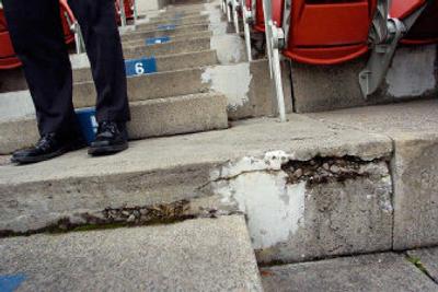 
Spokane Indians general manager Paul Barbeau shows light-colored areas that have been patched in the stands of Avista Stadium. Other areas show the extent of wear in the ballpark's concrete risers. 
 (Christopher Anderson / The Spokesman-Review)