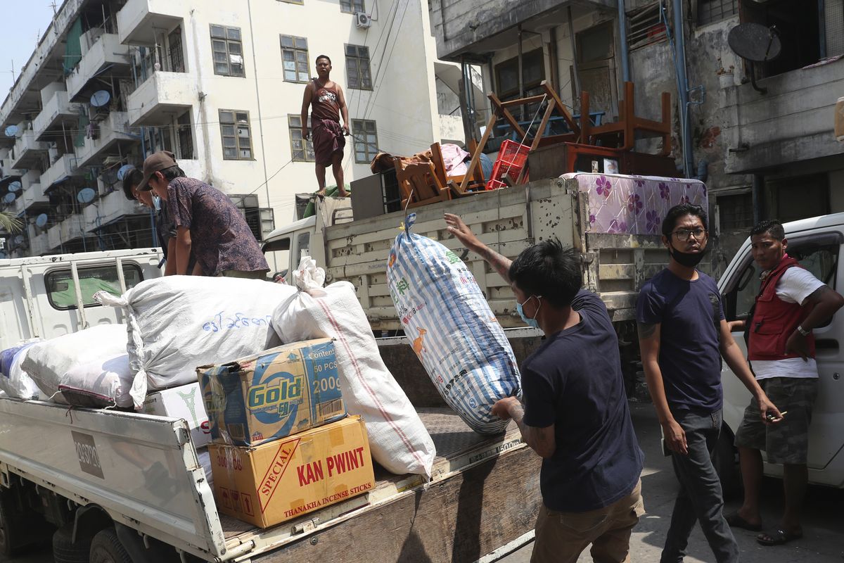 State railway employee load belongings after being evicted from their homes Saturday, March 20, 2021, in Mandalay, Myanmar. State railway workers in Mandalay have been threatened with eviction to force them to end their support for the Civil Disobedience Movement (CDM) against military rule.  (STR)